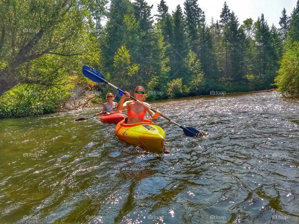 girls kayaking river