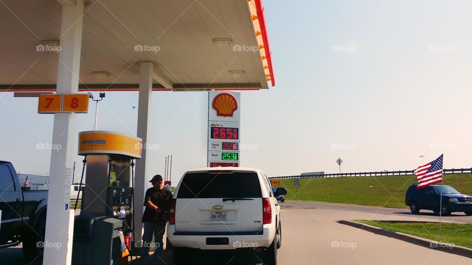 Man Filling Up a Vehicle with Fuel