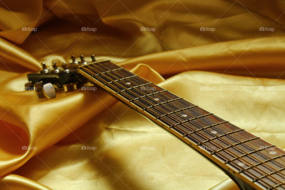 acoustic guitar on Golden textile