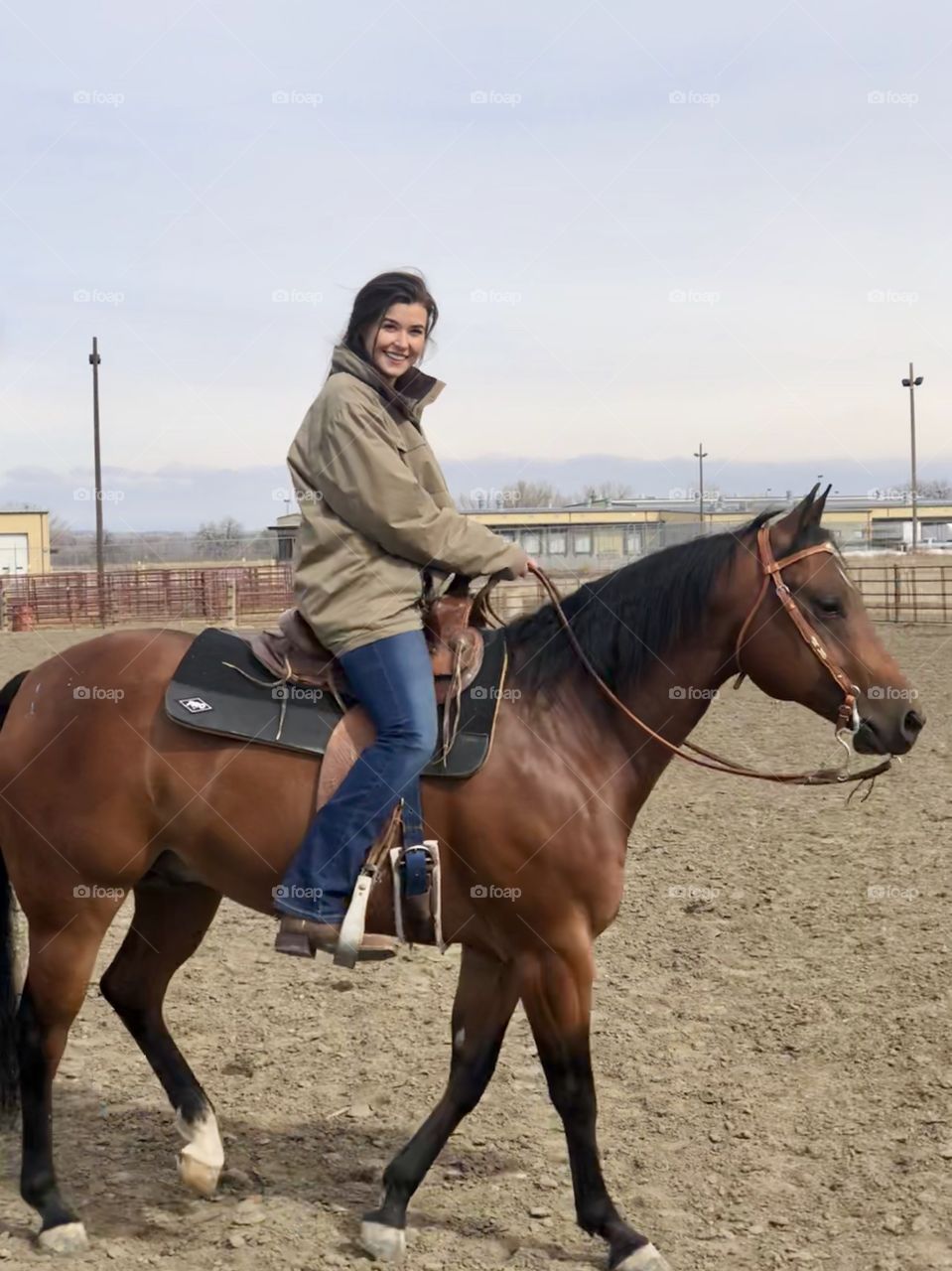 Brunette girl riding her bay quarter horse gelding. 