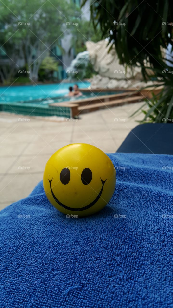 Smiley face on holidays. at the hotel pool