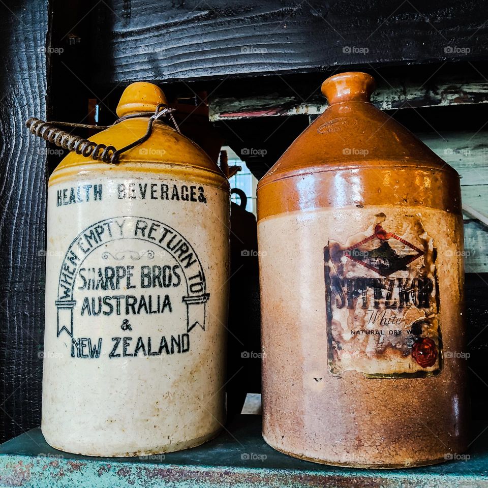 Demijohn glased stoneware bottles by Sharpe Brothers used for storing non alcoholic drinks such as ginger beer and dandelion ale. These made by Bendigo Pottery.