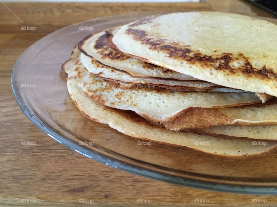 Stack of Russian pancakes on a transparent plate