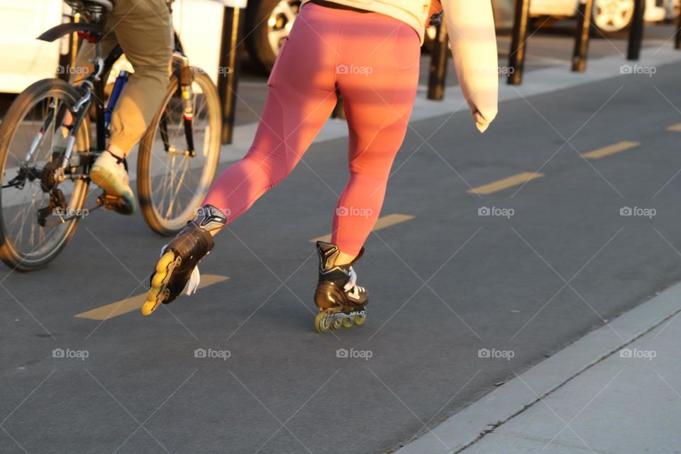 Biker and roller skater running on the road