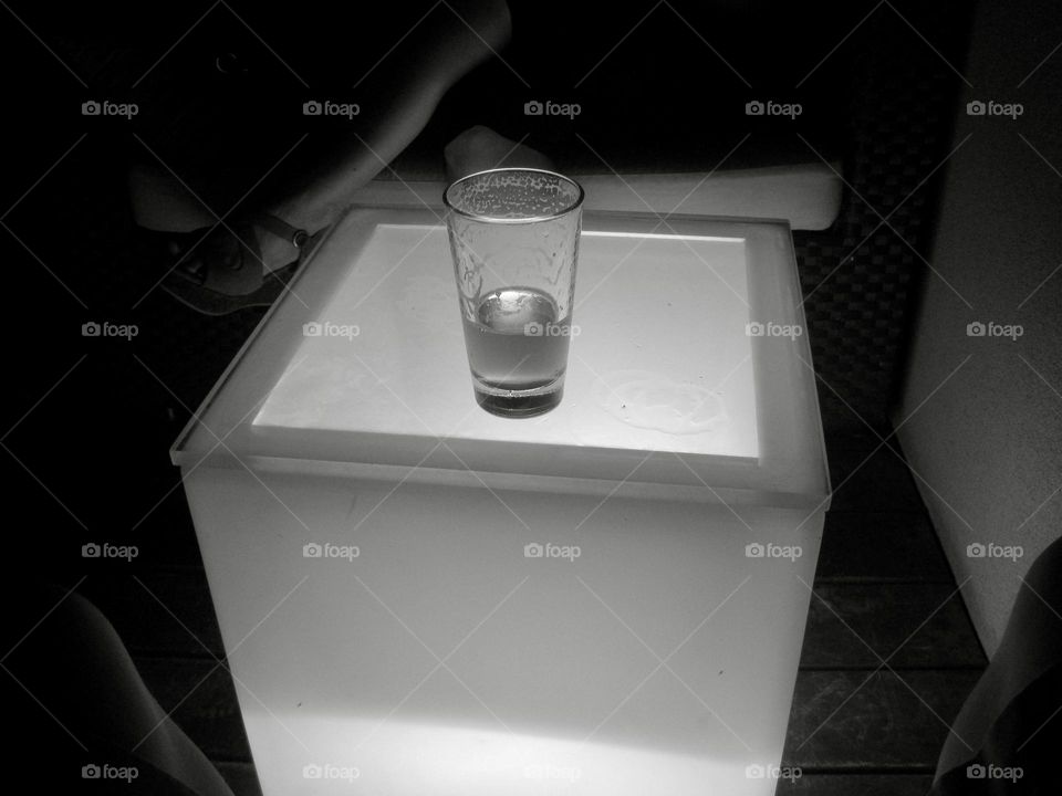 A pint of beer on a glowing cube table.