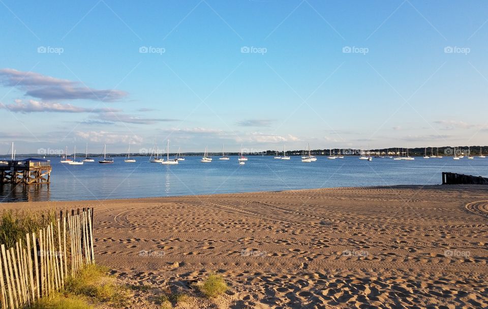 A fleet of sail boats sit in the Raritan bay in Perth Amboy, Nj.