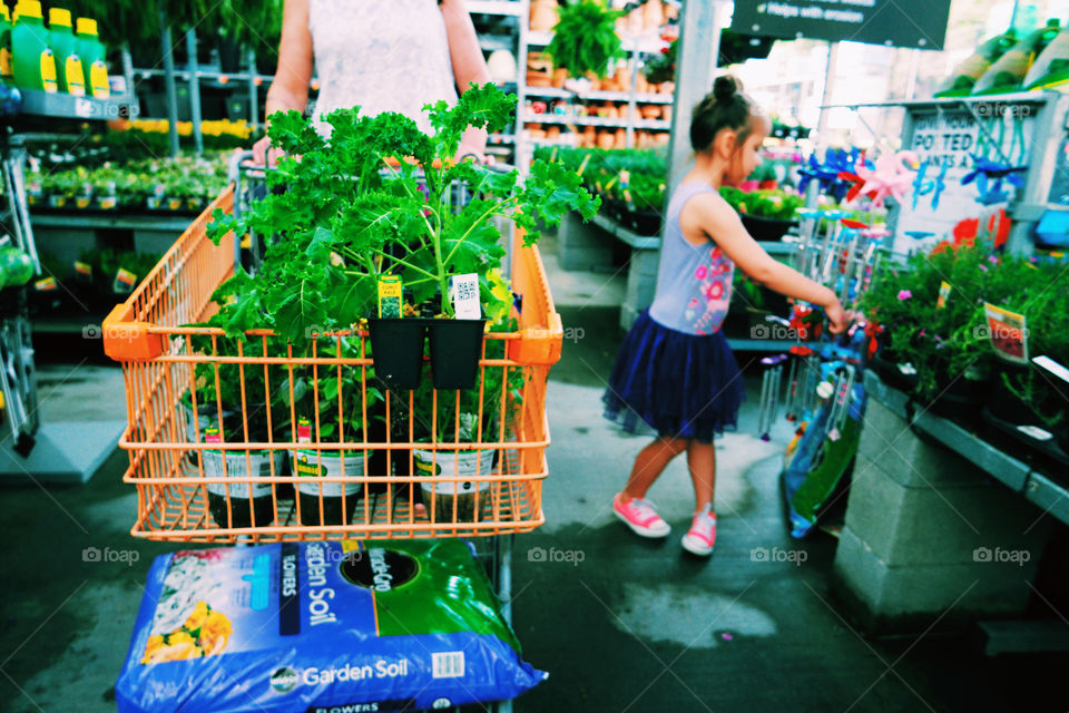 Kid shopping for flowers and plants 