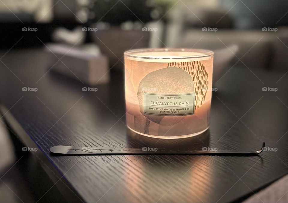 A bath and body works candle with a candle hook.