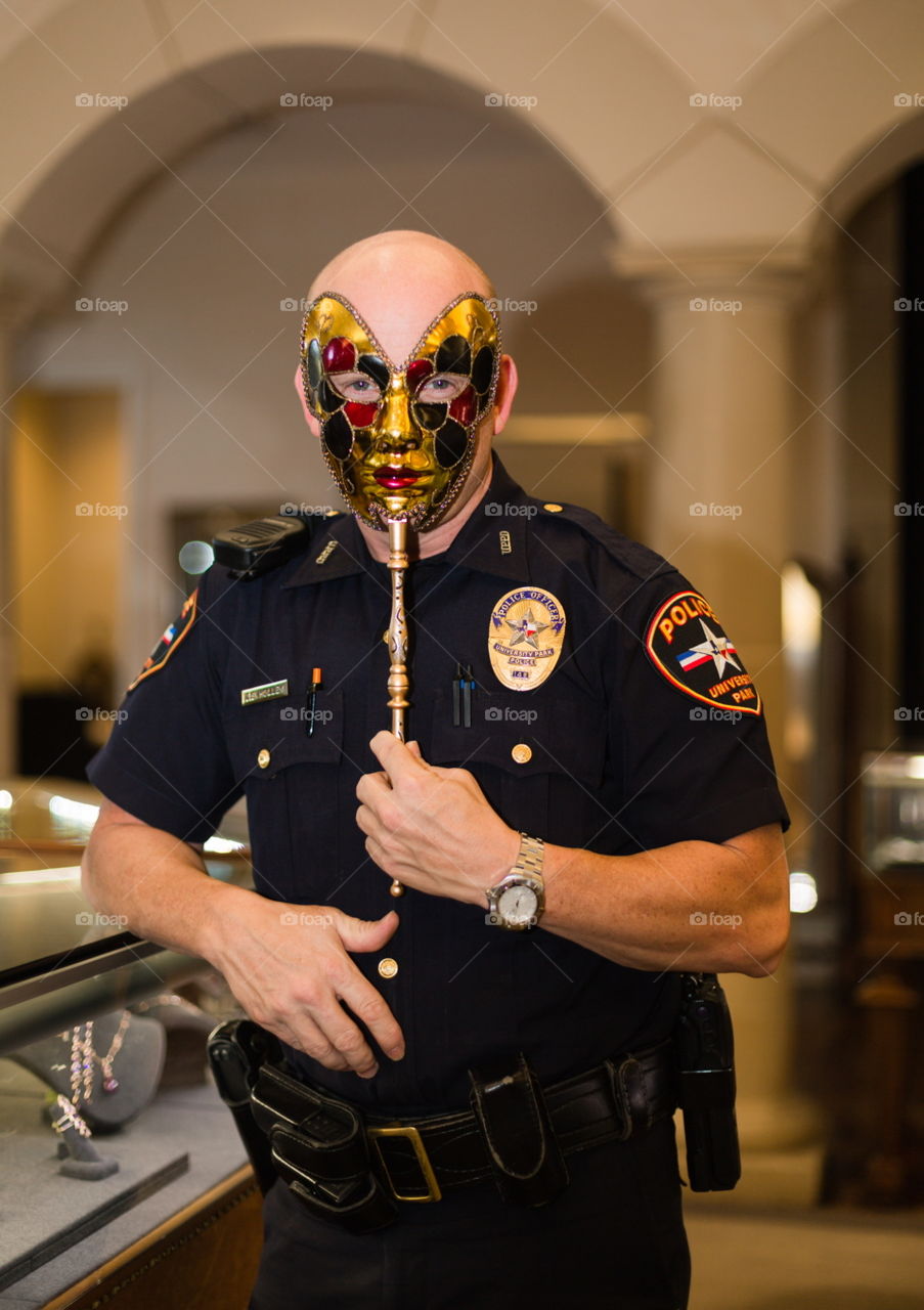 A Masked Officer. While shooting a jewelry store event, the hired officer masked his excitement. 