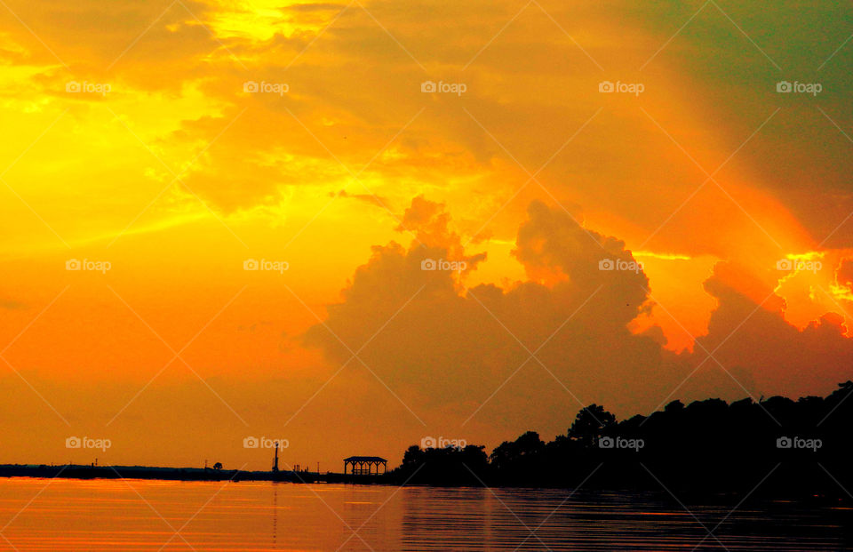 Mushroom Sunset. As the massive cloud structure collides with the sun rays, a magnificent sunset is formulated. The sky is radiantly seen