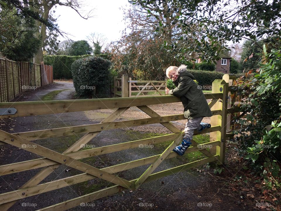 Swinging on the garden gate, Chertsey, Surrey, England