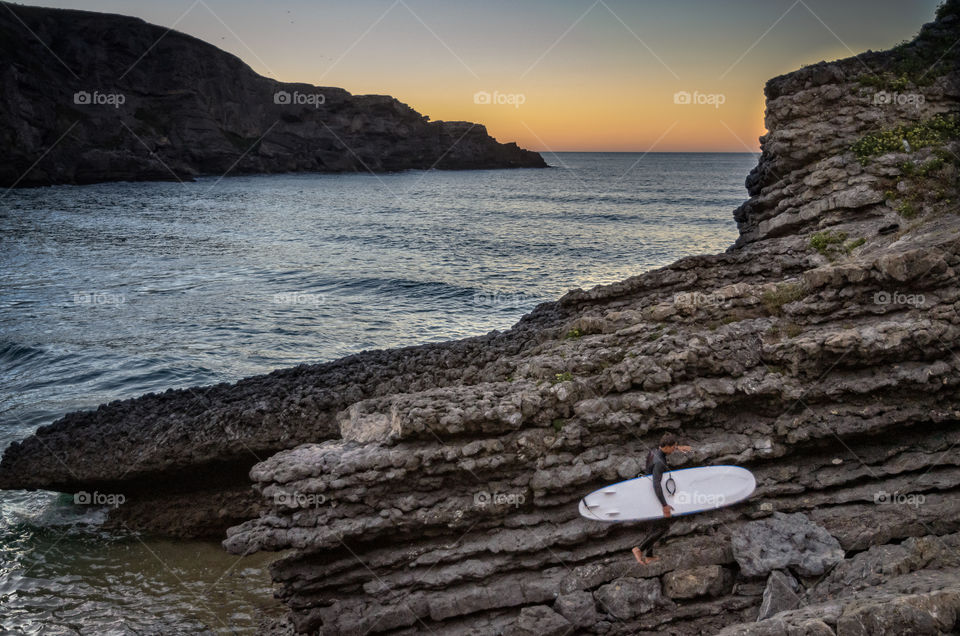 A surfer leaves the beach after Surfing 