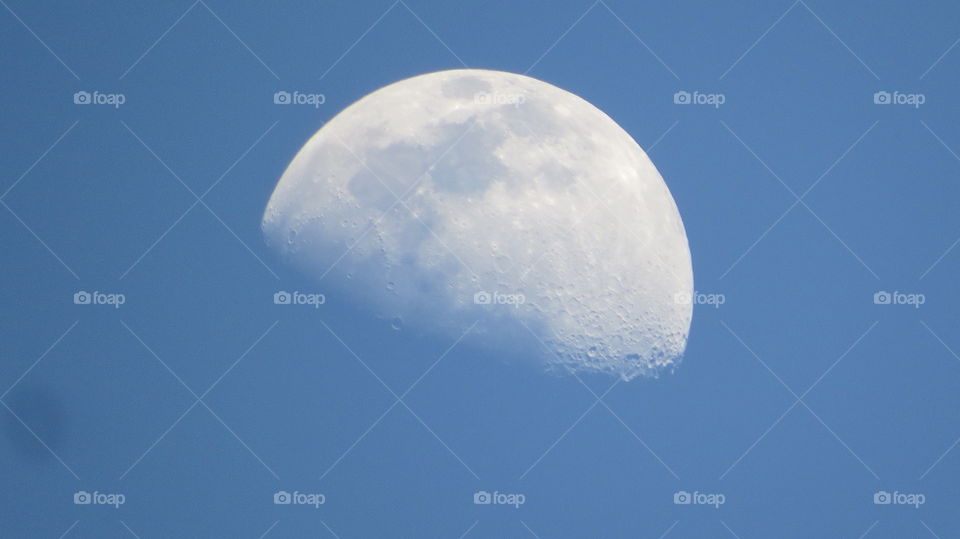 Half moon in the blue sky