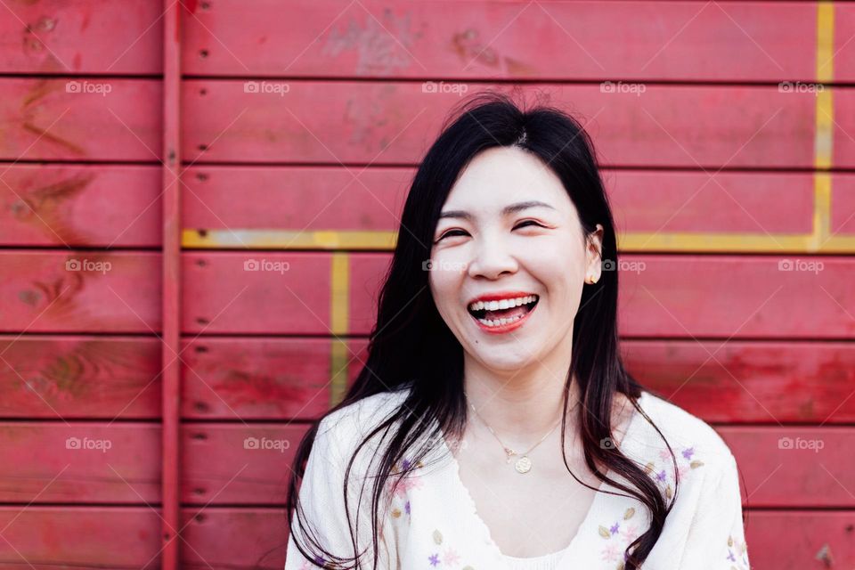 Candid life portrait of happy asian brunette woman