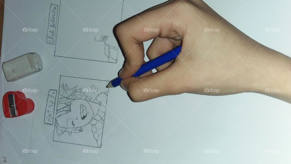 little hand draws animated face by blue pencil.