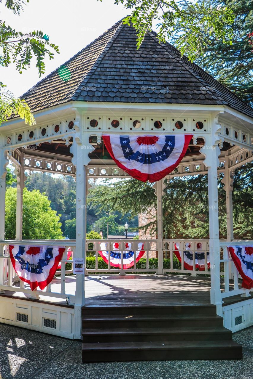 Gazebo in a small town decorated for the Fourth of July with festive American flag bunting 