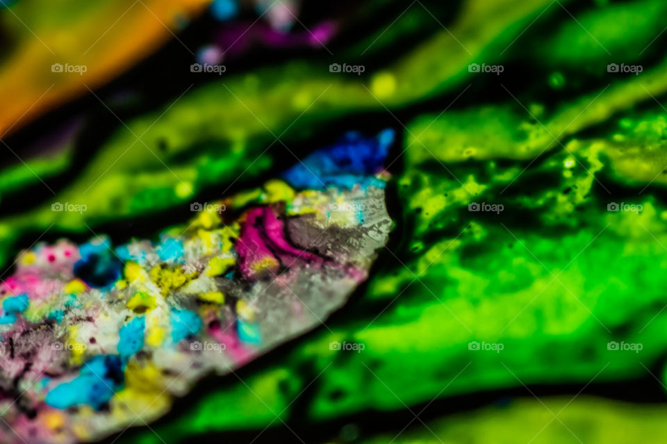 The ink to refill the printer cartridge was spilled onto the white washbasin and the paints blended into abstract drips and patterns.