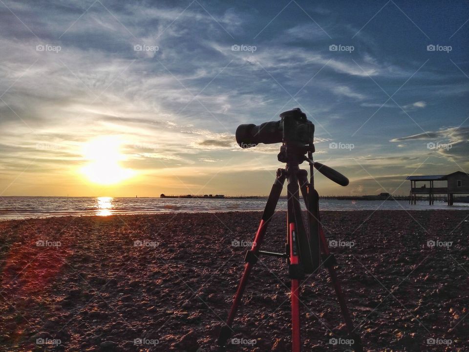 Taking pictures of landscape against sunset
