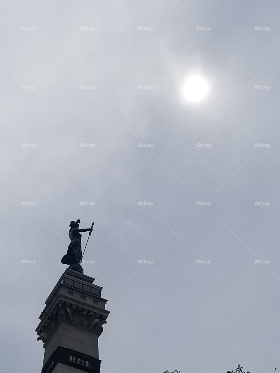 Beauty of the sun light hidden within the clouds high above the monument!!