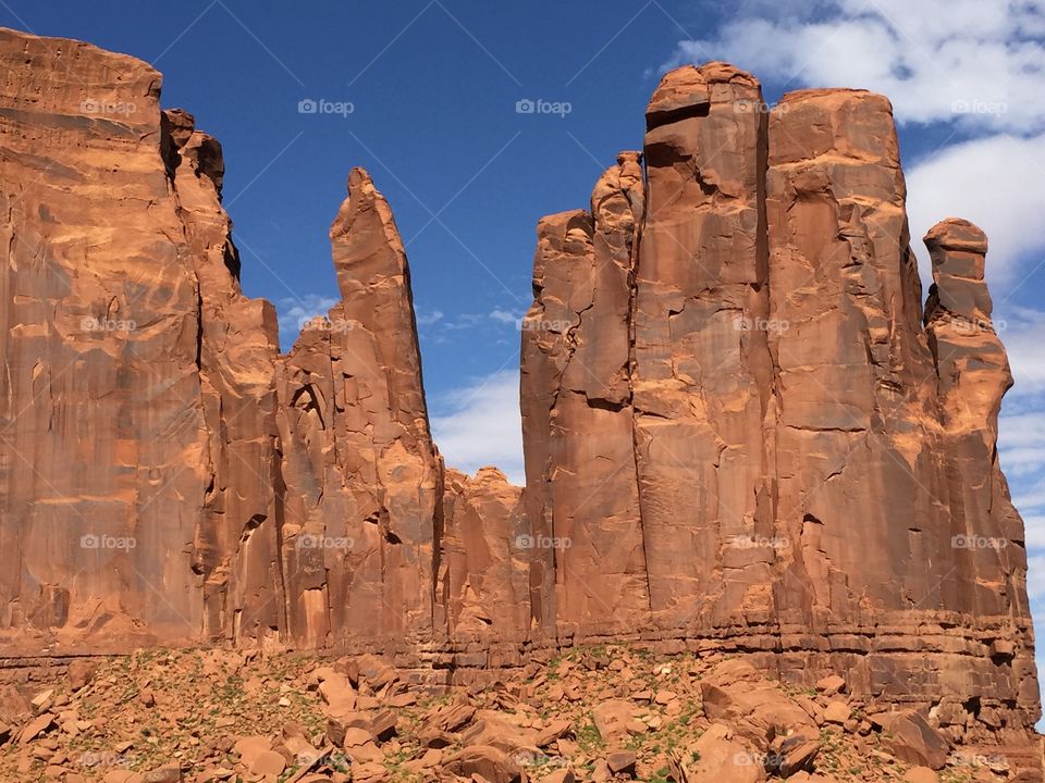 Rock formation against cloudy sky