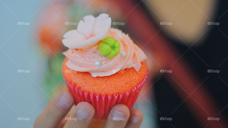 Strawberry cupcake with floral accents.