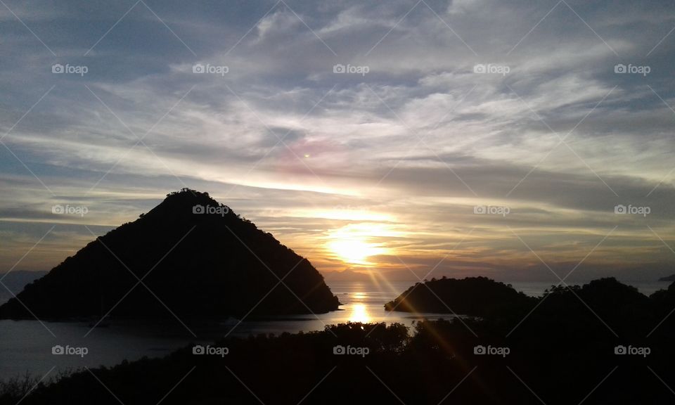 sunset labuan bajo seen from the top of silvia hill. this is a scene that beautify the appearance of the island known for its ancient animals that are second to none in the earth is a commodity.