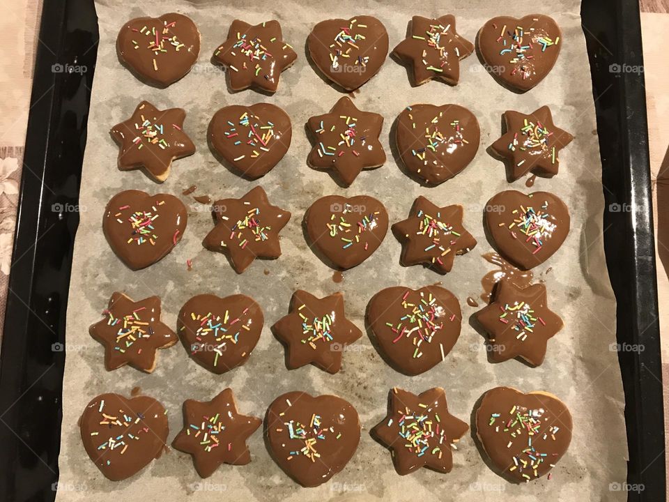 Sweet sugar cookies with chocolate coating and sprinkles