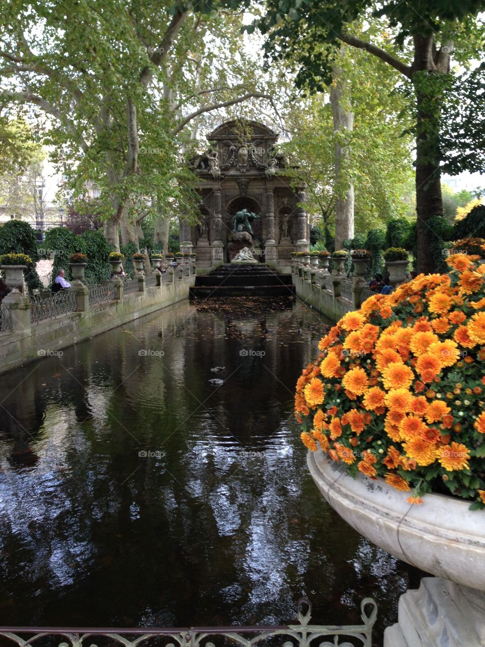 Fountain and flowers in Paris park. 