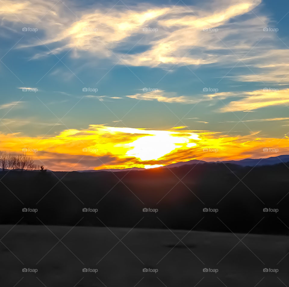 A colorful sunset fading behind the Blue Ridge Mountain range. 