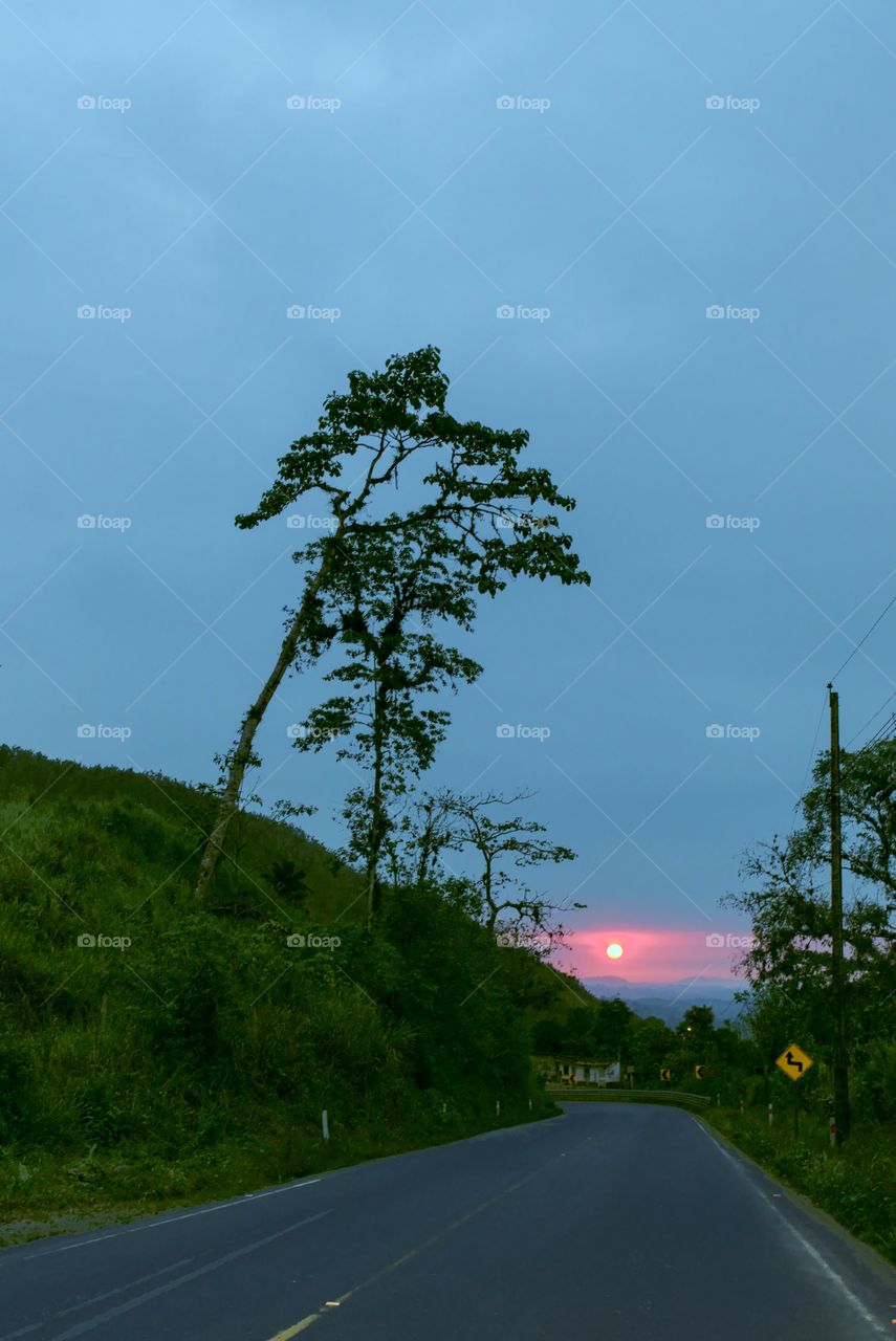 Sunset with blue sky on the road and skyline in the middle of the mountains