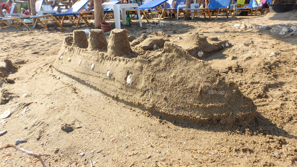 boat made from sand on the beach