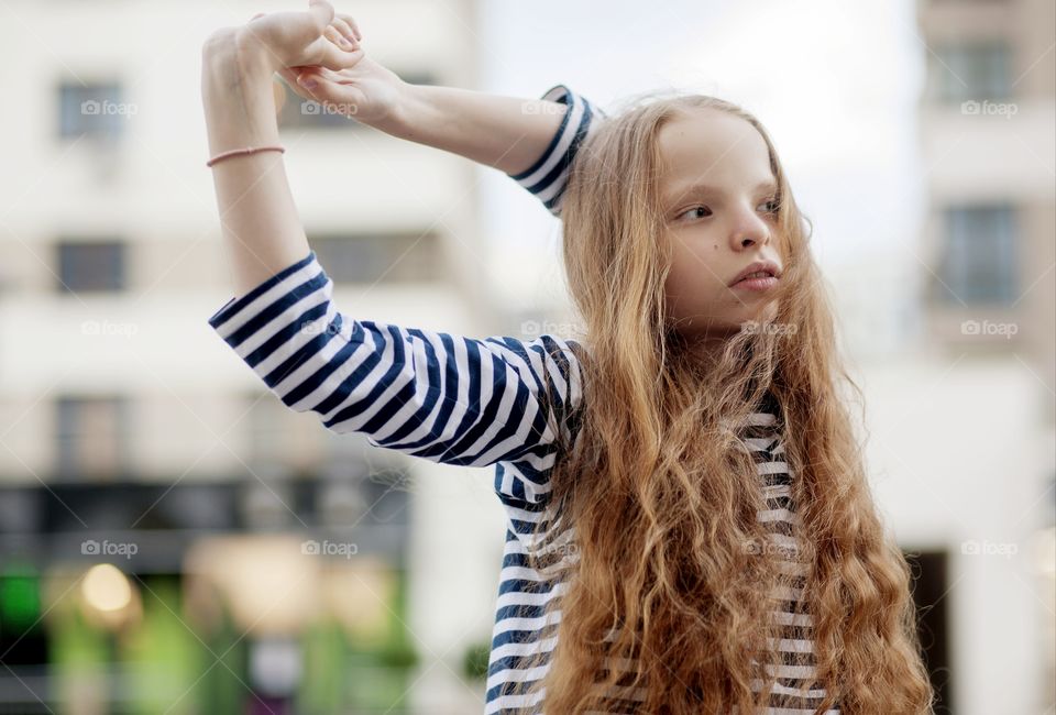 A red-haired girl in a striped sweatshirt