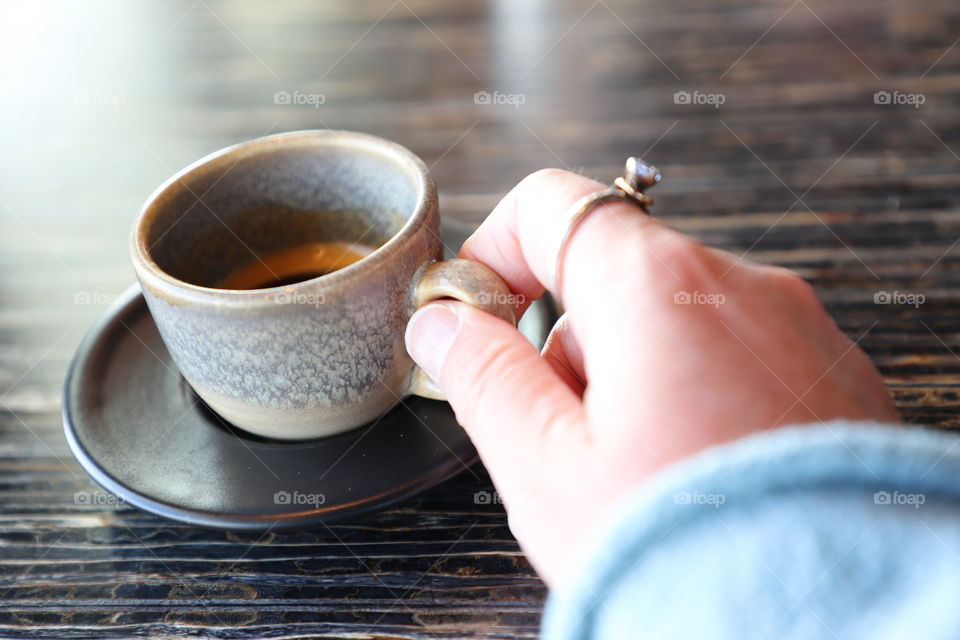 Human hand holding a cup 