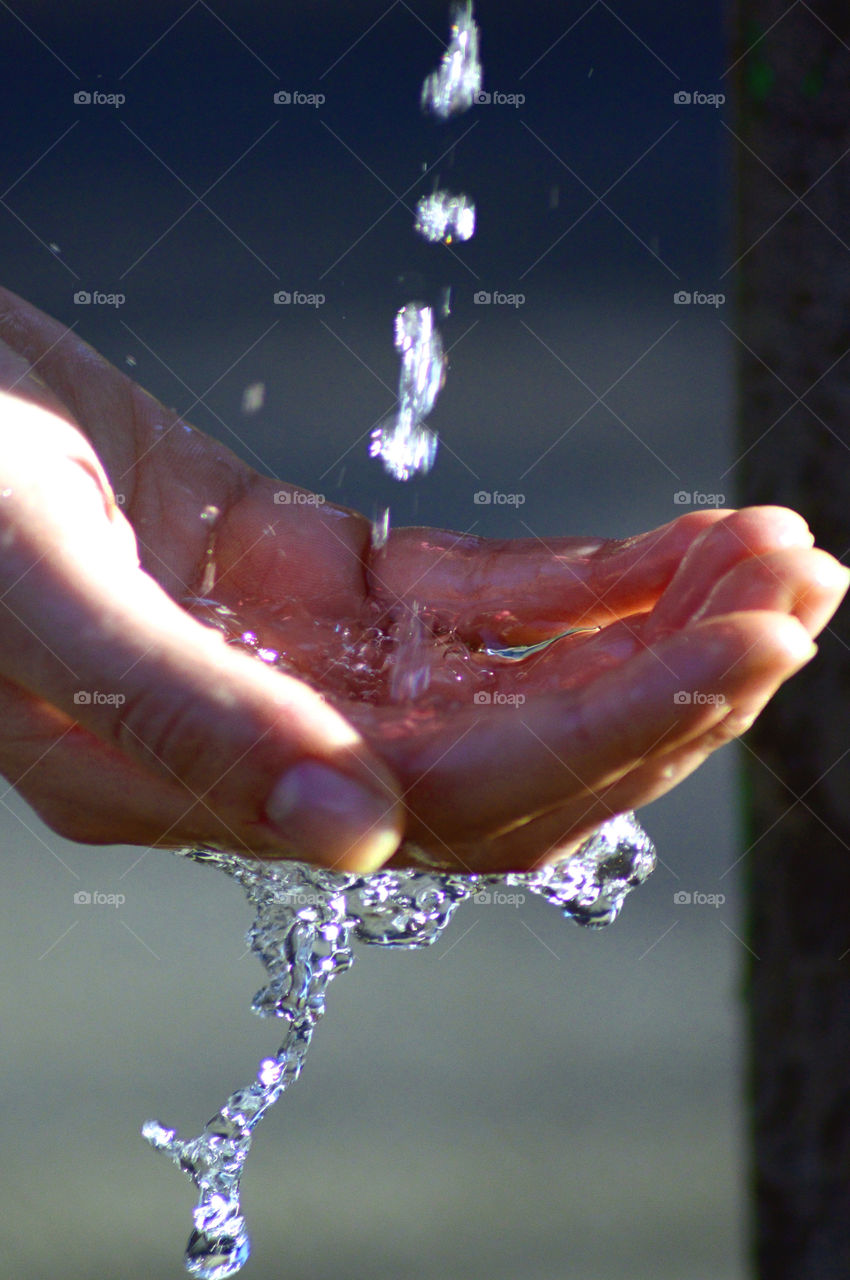 Human hand with falling water