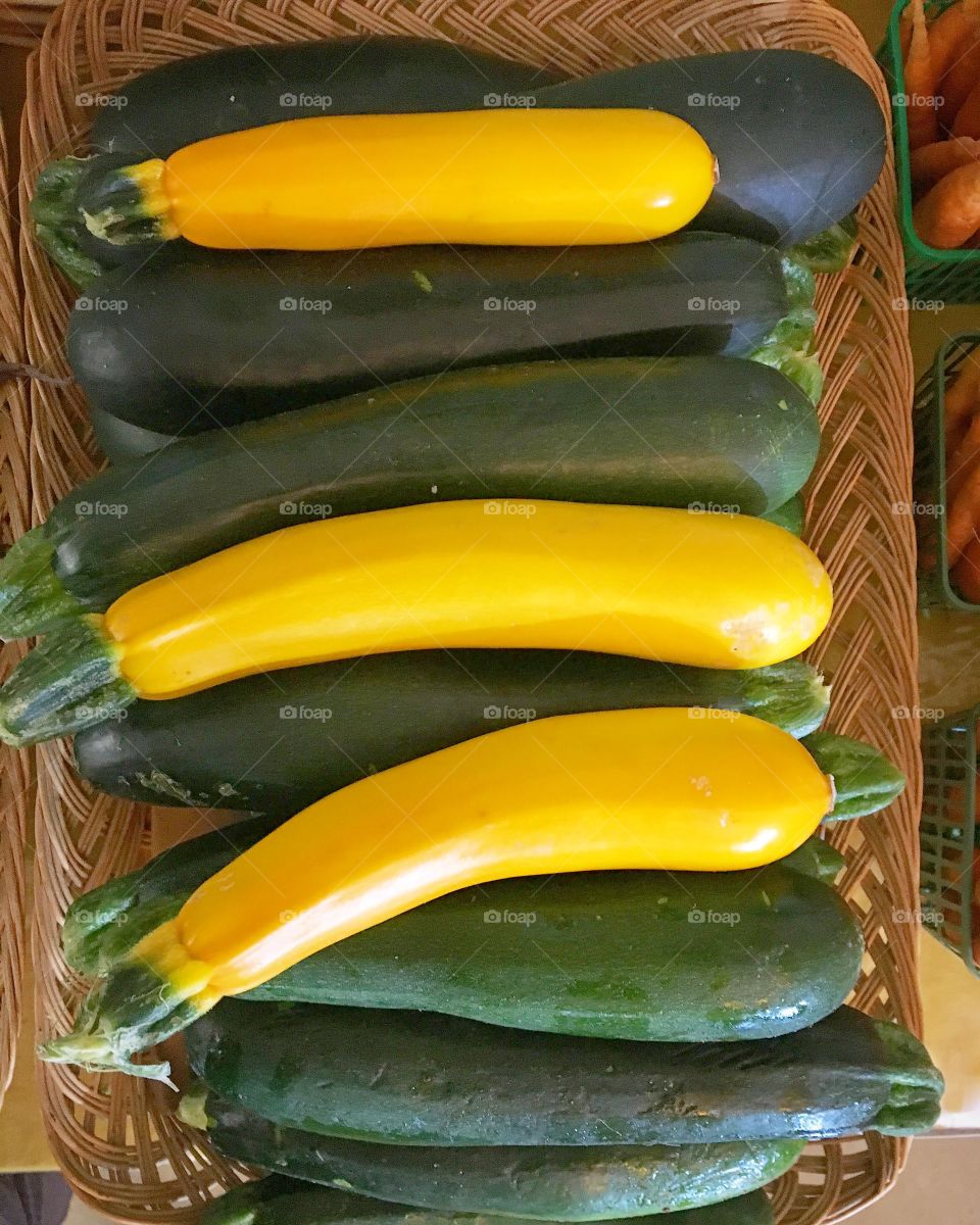 An assortment of bright yellow and green organic zucchini await customers at an organic farm store in the Niagara region. 