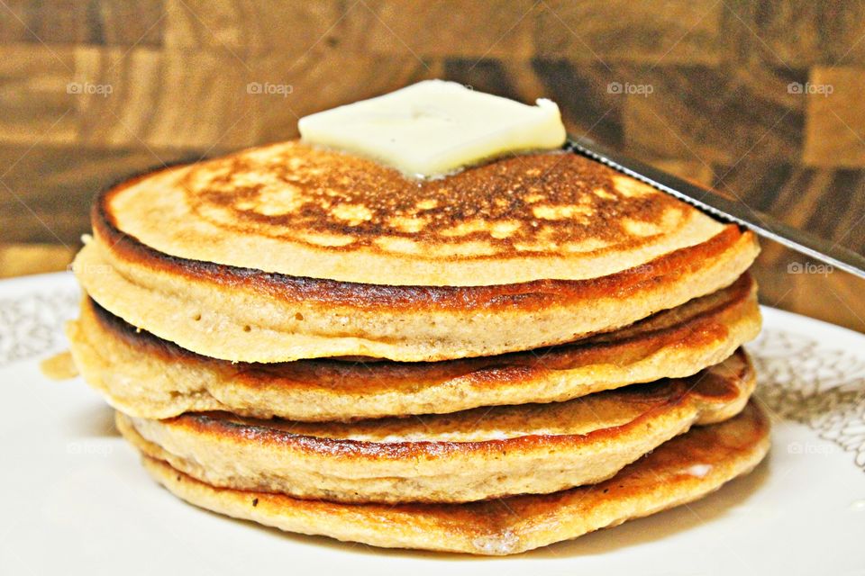 homemade pancakes, flapjacks, griddle cakes with butter on top