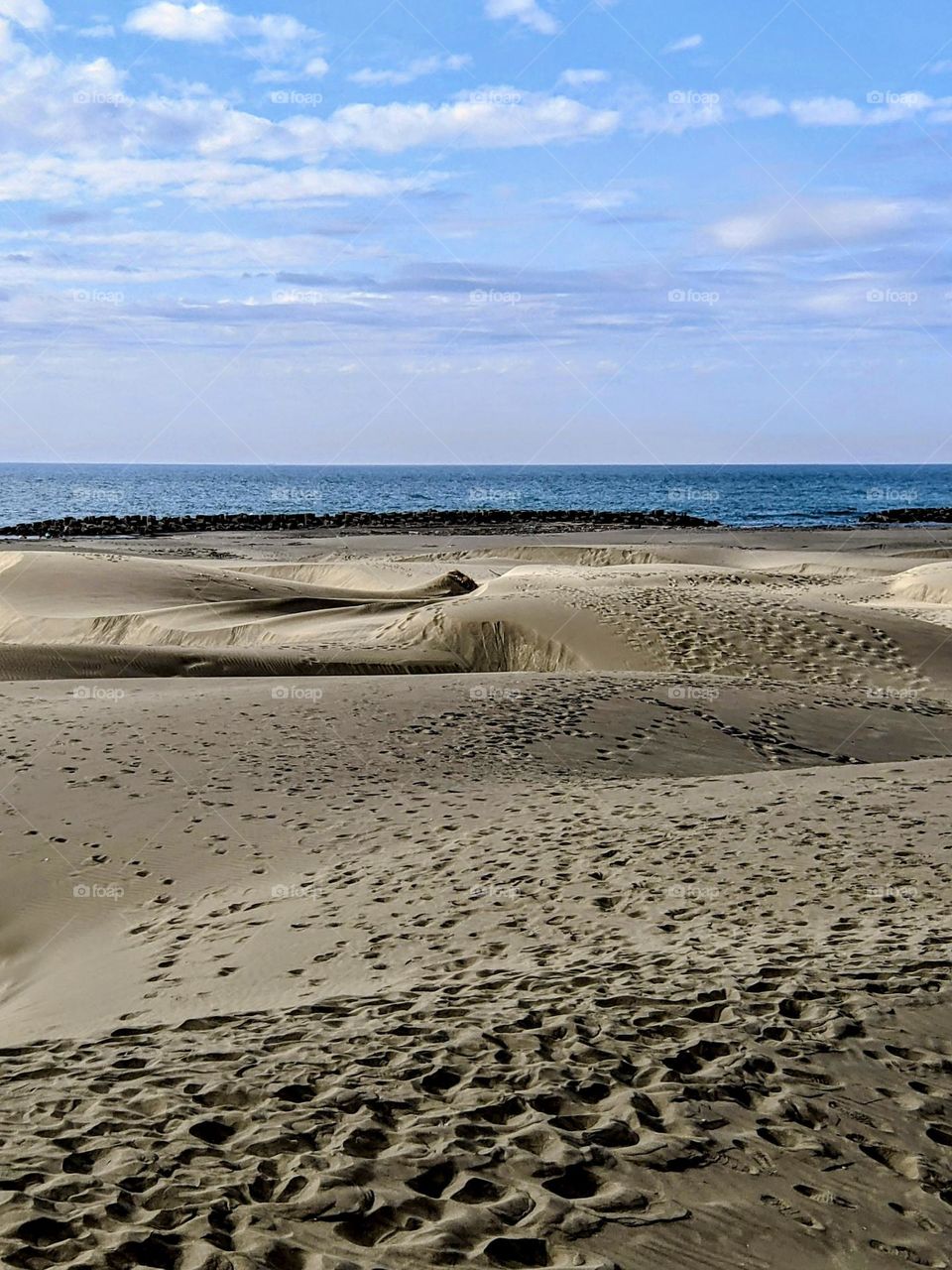 Beautiful beach with many footprints