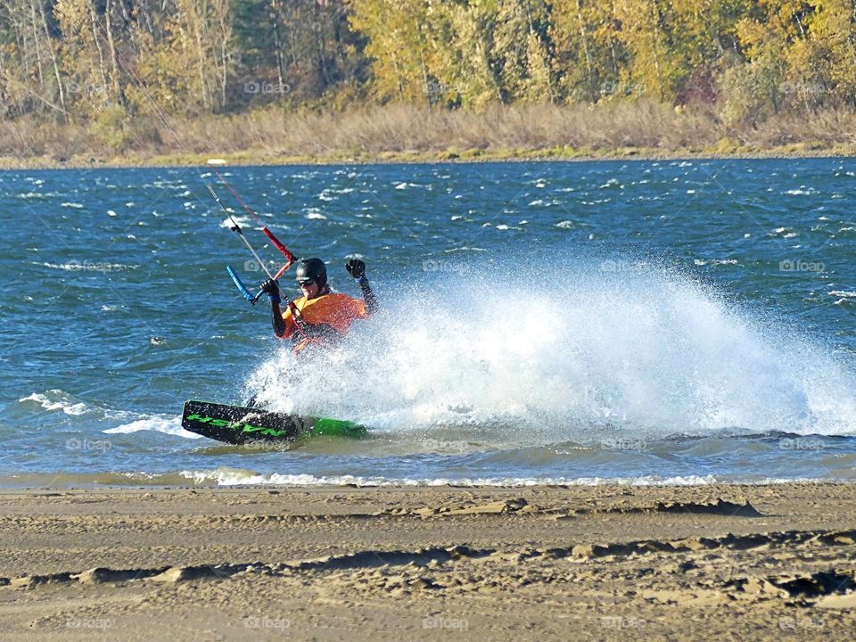 kiteboarding turn with water spray