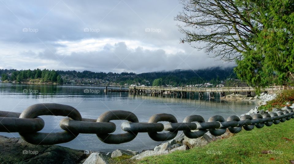 Nautical anchor chain foreground framing beautiful belcarra bay near Vancouver, British Columbia 