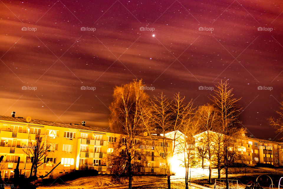 the stars and wispy clouds over the neighbourhood on a cold winter night
