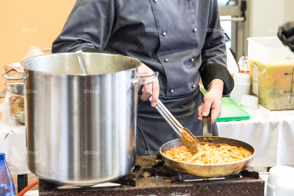 Chef In The Hotel Kitchen Restaurant Prepares Pasta Macaroni
