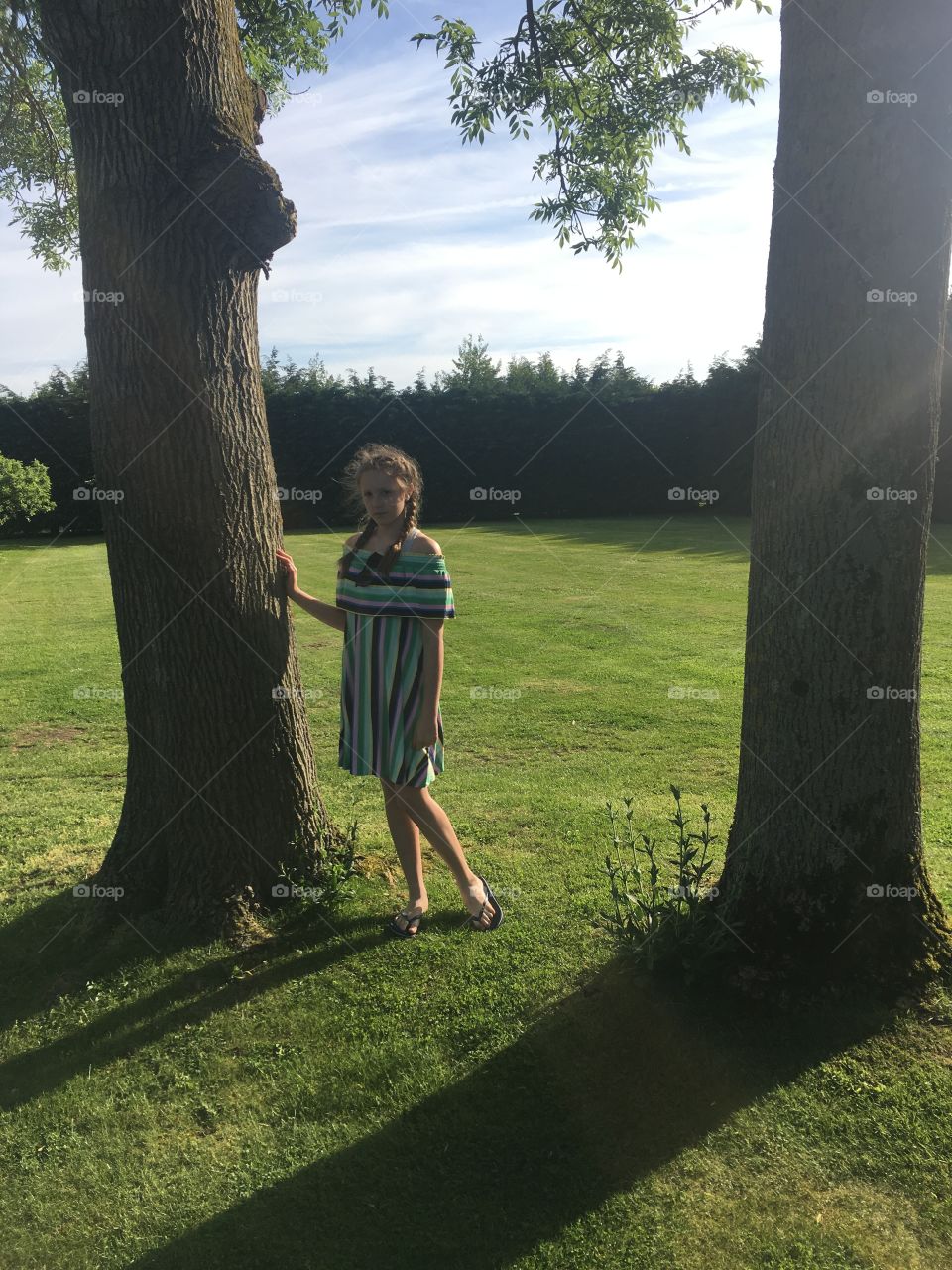 My beautiful daughter at the winters barn gardens between 2 trees in the sunshine in May 