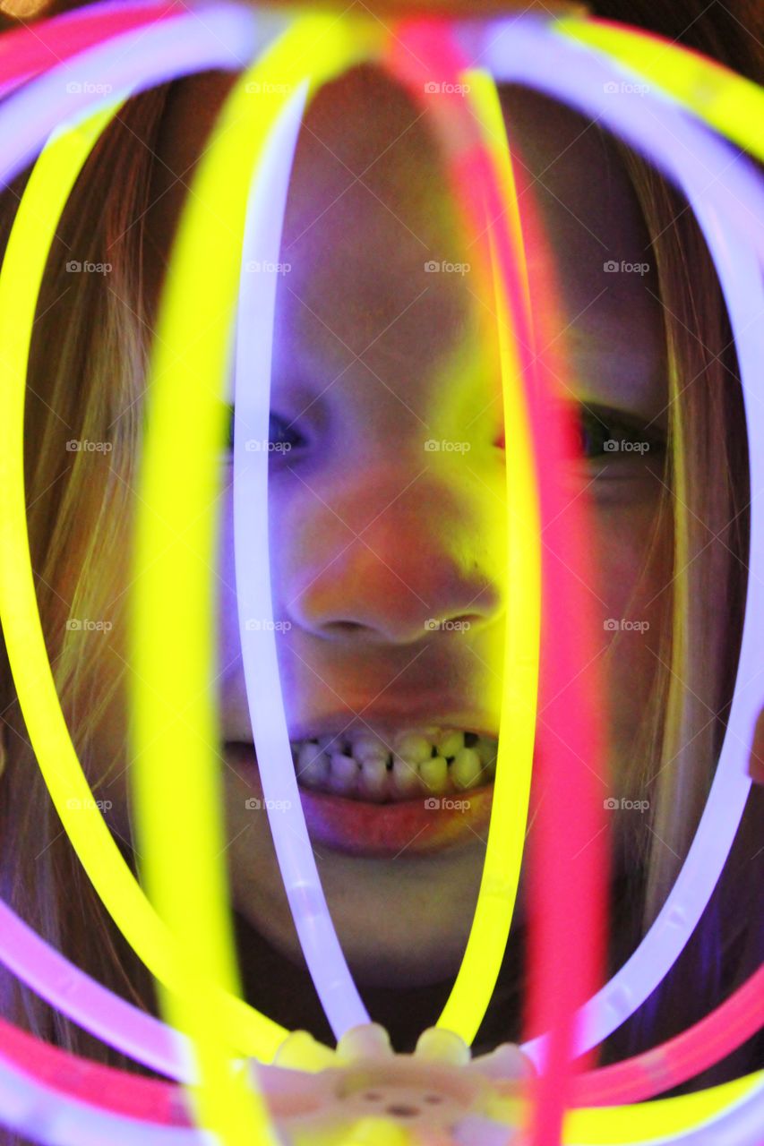 Child playing with glows sticks 