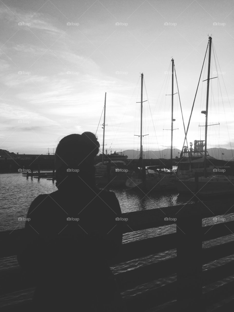 WOMAN OVERLOOKING DOCKS