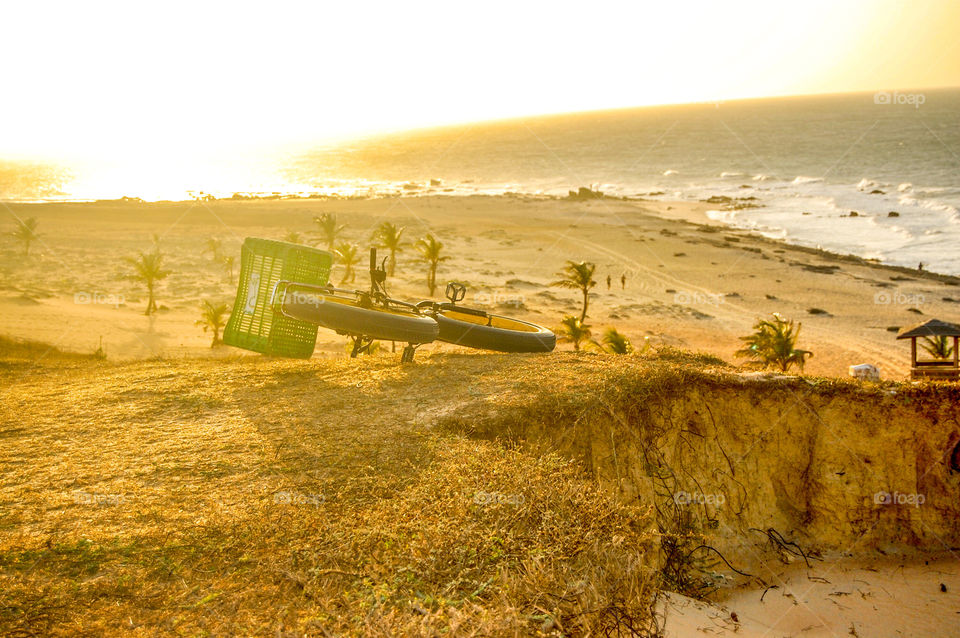 Bicycle parking on mountain against beach 