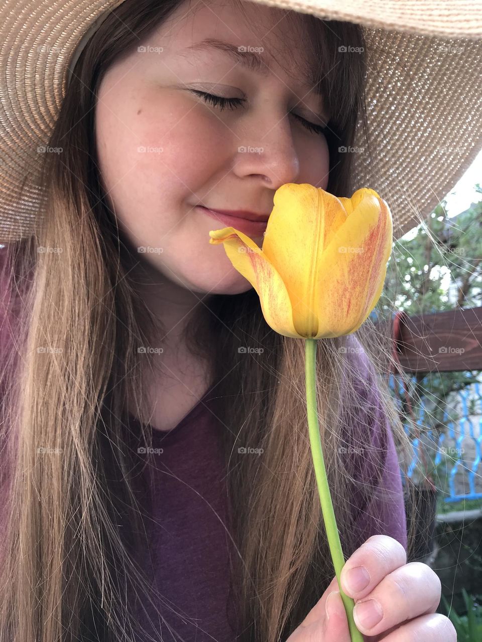 A girl with yellow tulip