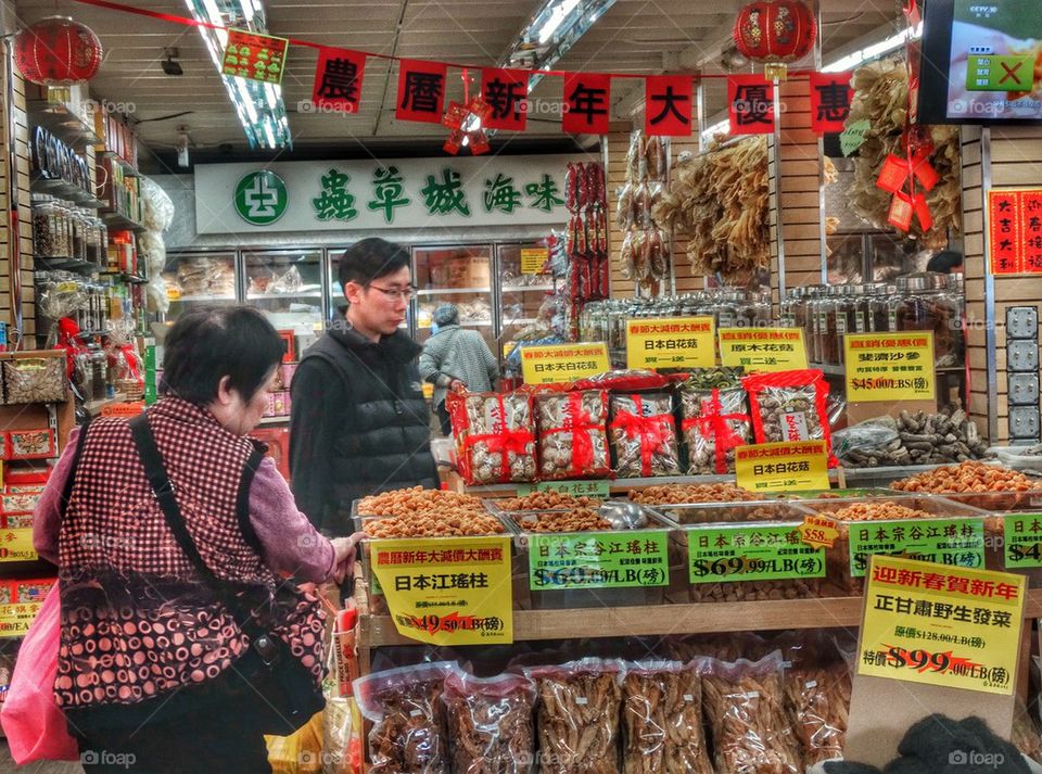 Dried Fruits In A Chinese Market. Shoppers In A Chinese Market
