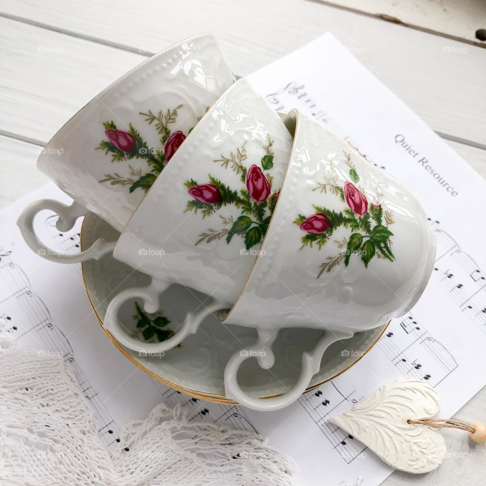 Old porcelain cups with roses ornament