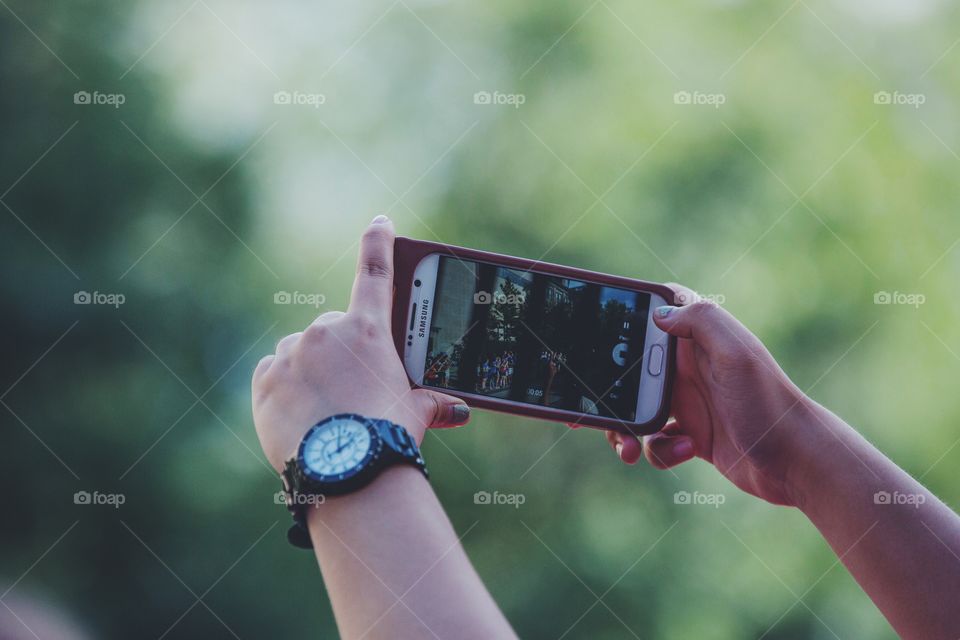Two hands taking a photo on a smartphone