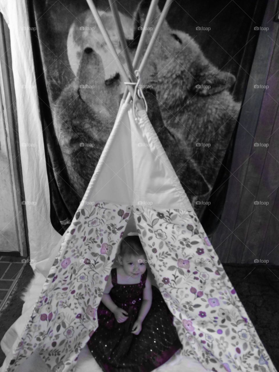 Elevated view of a cute girl sitting in tepee